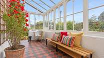 Enter through the marvellous conservatory. 