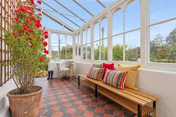 Enter through the marvellous conservatory.