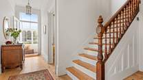Venture up the beautiful wooden staircase to discover the other bedrooms.