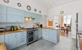 The splendid modern kitchen opens up to the dining area. - Thumbnail Image