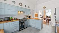 The splendid modern kitchen opens up to the dining area.