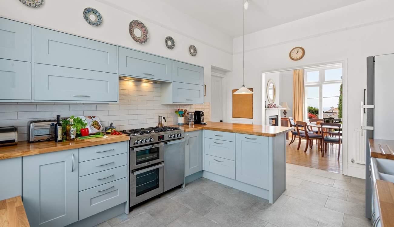 The splendid modern kitchen opens up to the dining area.