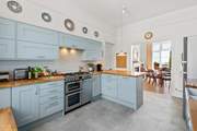 The splendid modern kitchen opens up to the dining area.