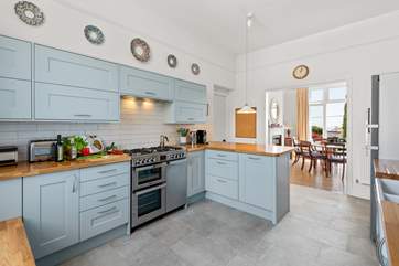 The splendid modern kitchen opens up to the dining area.