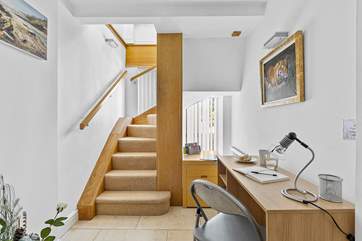 The stairs lead down to the two bedrooms on the lower ground floor. This convenient desk is perfect if work calls.