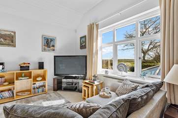 The open plan living space is on the ground floor, with two bedrooms on the lower ground floor.