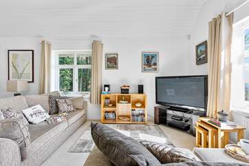 Triple-aspect windows let the light flood into the living-room, the talented owner's paintings are sure to make you smile!