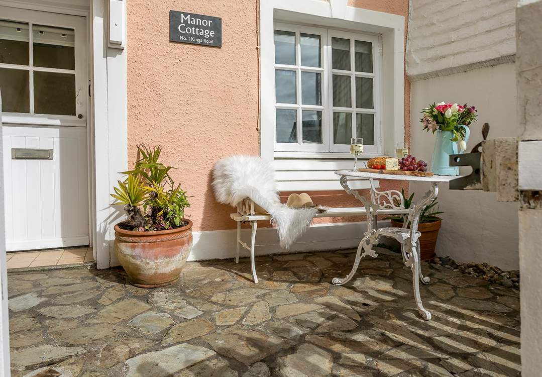 Enjoy watching the world go by from the small front courtyard.