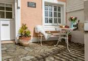 Enjoy watching the world go by from the small front courtyard.