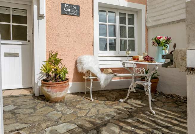 Enjoy watching the world go by from the small front courtyard.