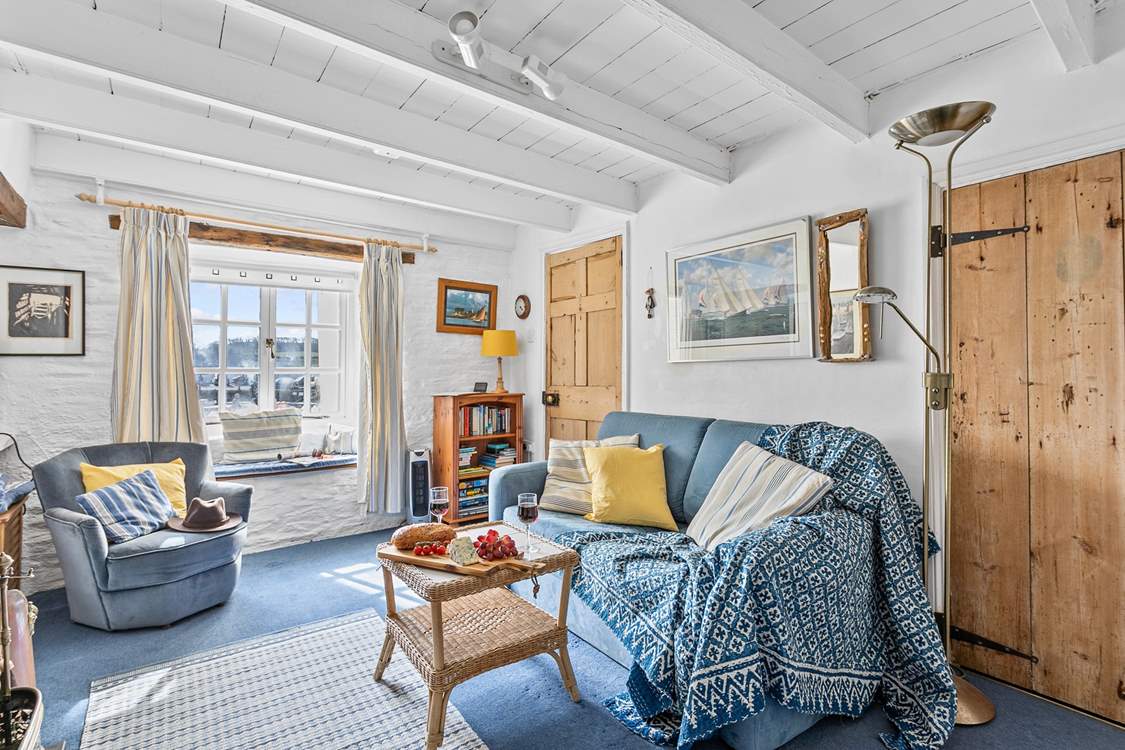 The characterful sitting-room looks out towards the harbour.