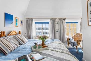 The twin bedroom to the front of the cottage has harbour views.
