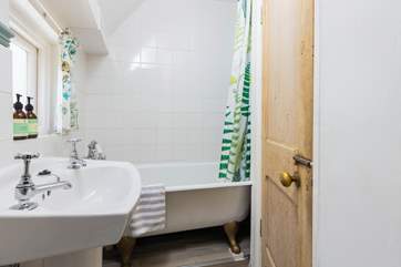 The family bathroom with three-quarter size bath and fitted shower is cosy and functional.