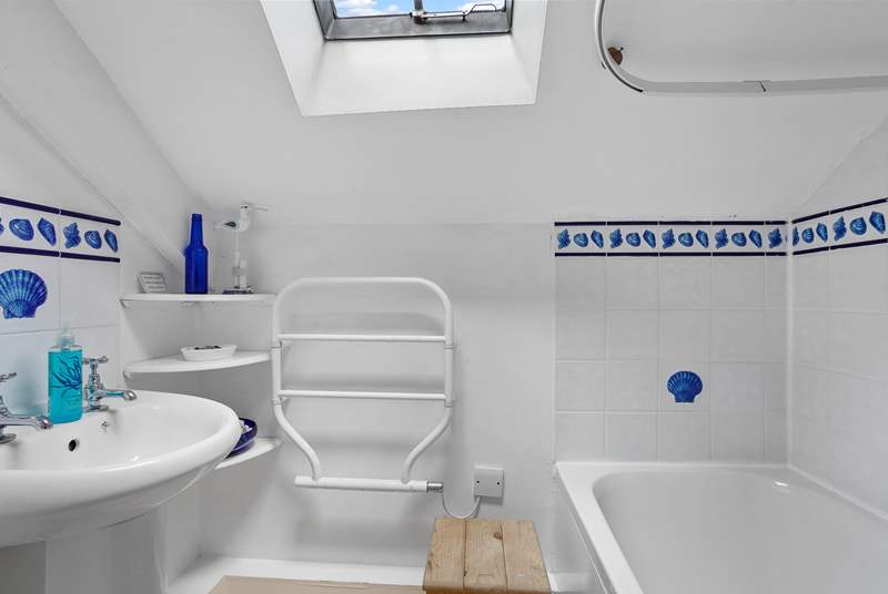 The functional family bathroom has a bath with shower over.