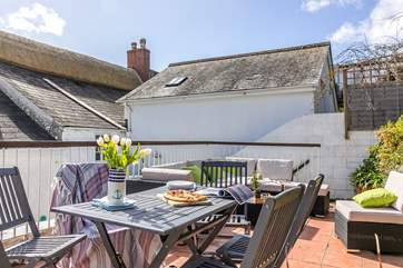A raised terrace at the rear of Our Cottage provides ample seating. Please note this is up a flight of steps.