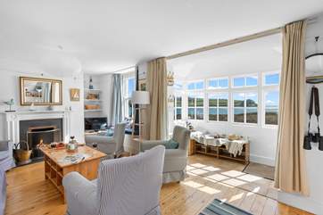 The open plan sitting/dining-room has fabulous waterfront views.