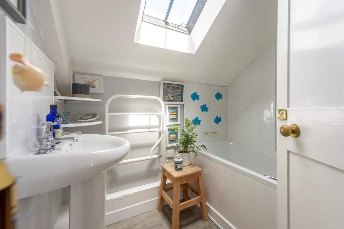 The functional family bathroom has a bath with a fitted shower.