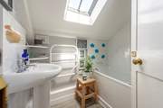 The functional family bathroom has a bath with a fitted shower.