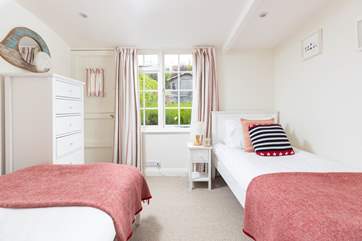The twin bedroom overlooks the pretty garden to the rear.