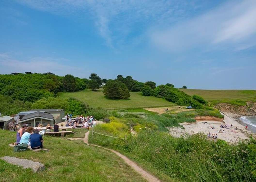 The Hidden Hut sits overlooking Porthcurnick beach and can be reached via the coast path.
