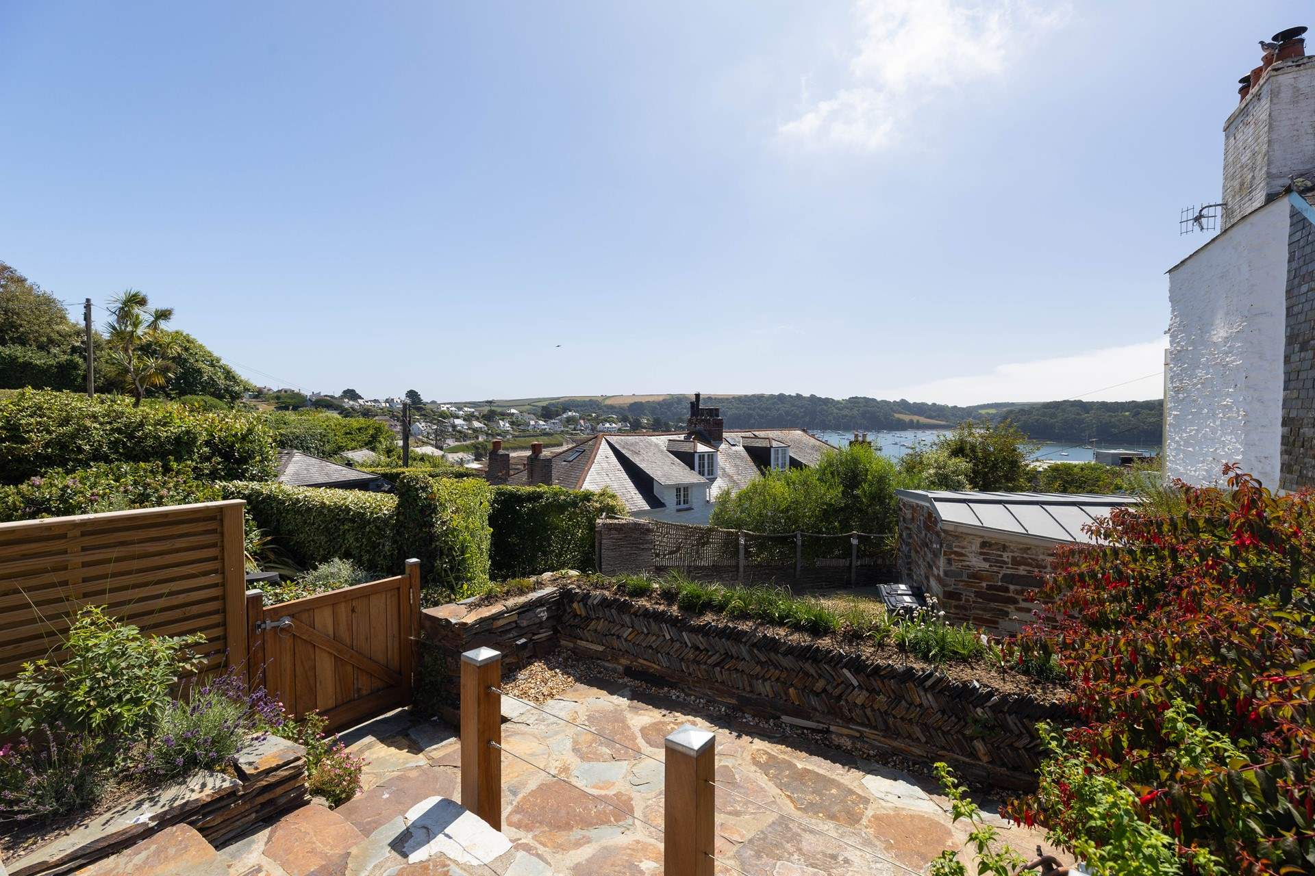 The front patio shares the same stunning view over the harbour and beyond to Place and St. Anthony headland.