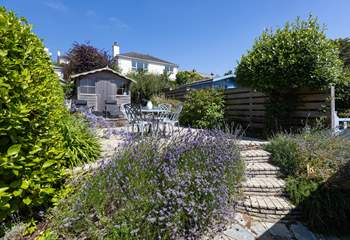 Steps lead up to a secluded patio at the rear of the cottage, the perfect place for al fresco dining.
