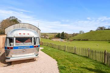 The American Airstream proudly sits at the edge of a working farm.