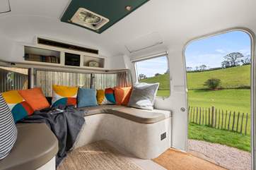 Fresh air and natural light flood in through the large door and windows.