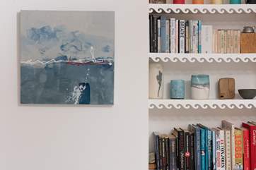 Fascinating books and enchanting paintings adorn the space.