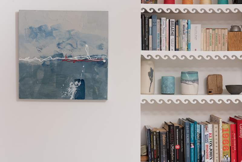 Fascinating books and enchanting paintings adorn the space.