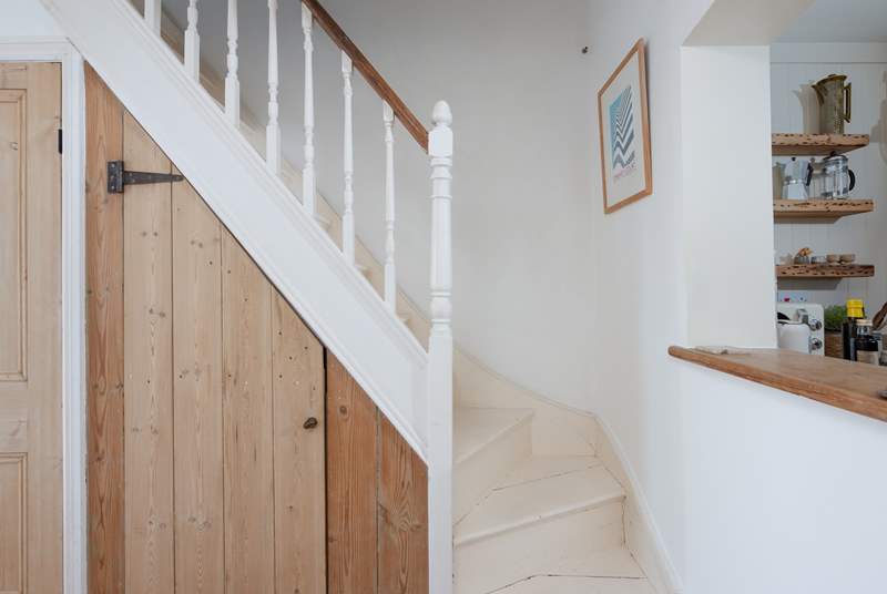 A compact staircase leads up to the first floor. The stairs are narrower and steeper than average and both bedrooms step out onto the stairs.