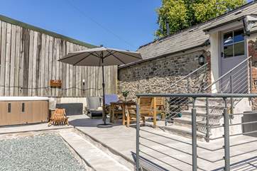 The back garden is a private haven with it's own hot tub and a lovely log burner!