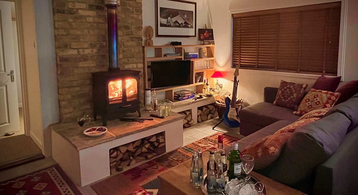 The cosy sitting-room with warming wood-burner is the perfect place to relax at anytime of year.