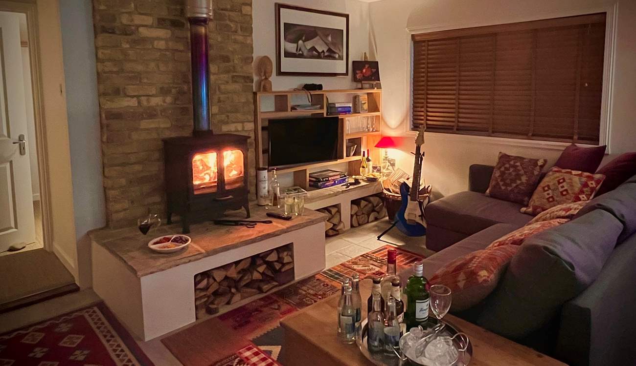 The cosy sitting-room with warming wood-burner is the perfect place to relax at anytime of year.
