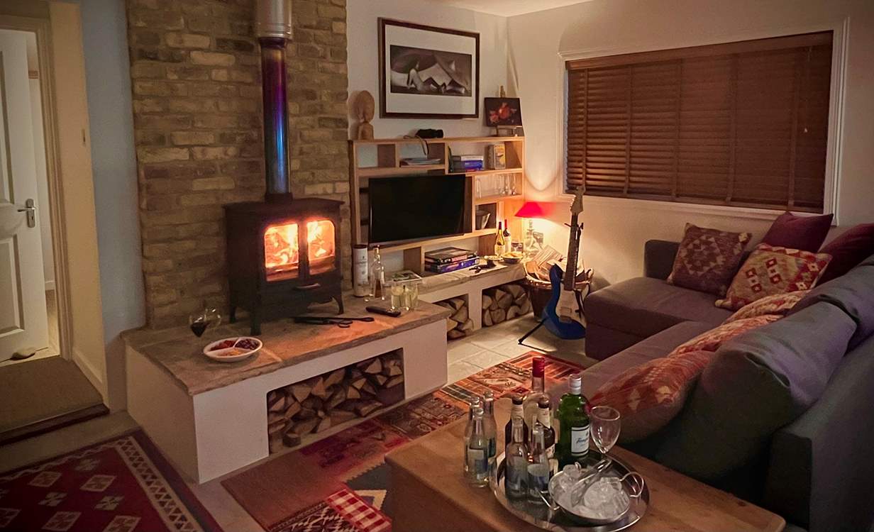 The cosy sitting-room with warming wood-burner is the perfect place to relax at anytime of year.