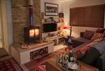 The cosy sitting-room with warming wood-burner is the perfect place to relax at anytime of year.