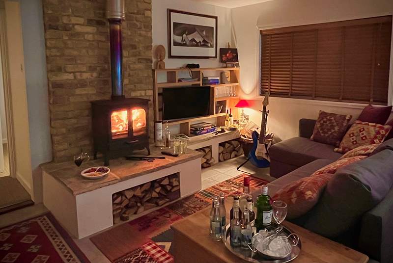 The cosy sitting-room with warming wood-burner is the perfect place to relax at anytime of year.