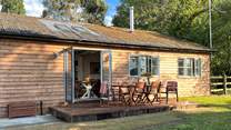 This gorgeous cabin sits in tranquil seclusion surrounded by woodland and pastures.