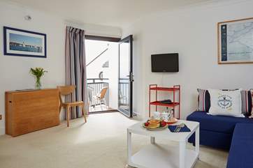 The open-plan living space has a nautical theme.