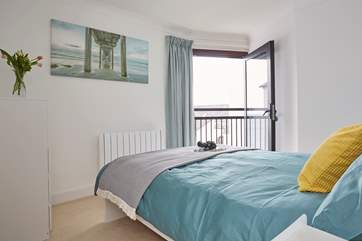 The pretty bedroom has a double bed and fabulous balcony.