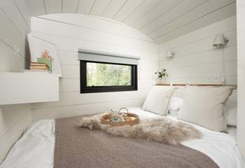 The sumptuous bed and luxurious linens promise a peaceful night's sleep. 