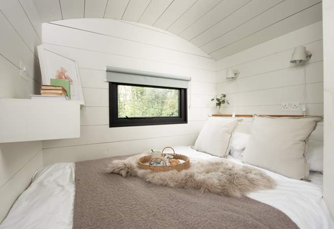 The sumptuous bed and luxurious linens promise a peaceful night's sleep. 