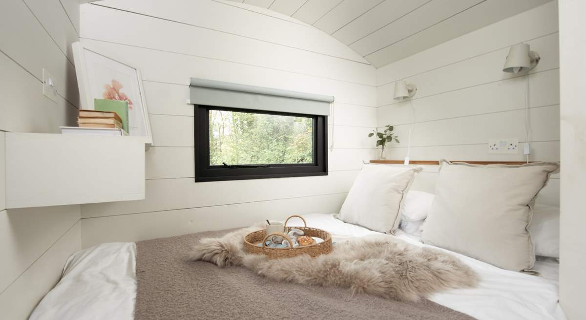 The sumptuous bed and luxurious linens promise a peaceful night's sleep. 