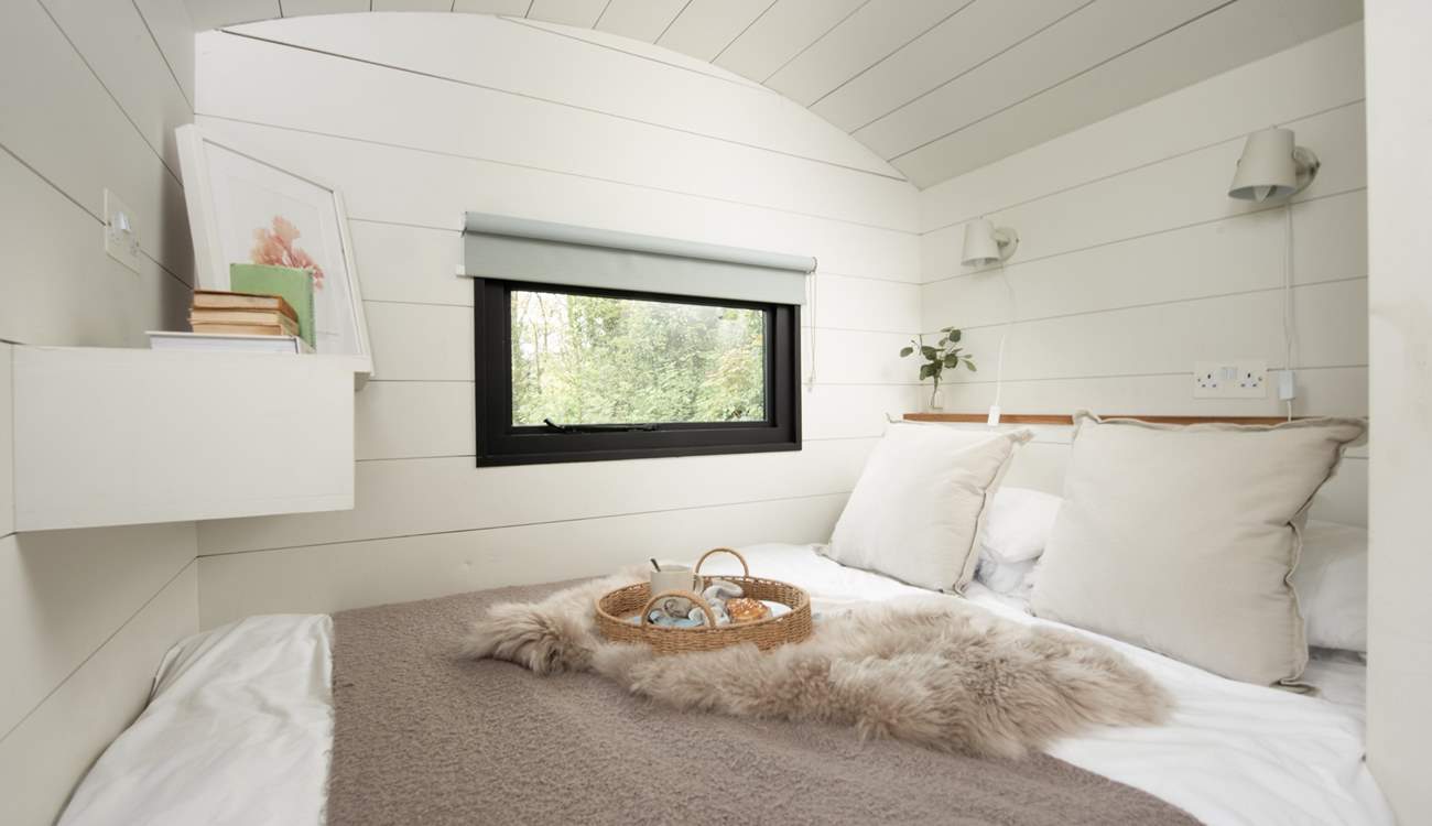 The sumptuous bed and luxurious linens promise a peaceful night's sleep. 