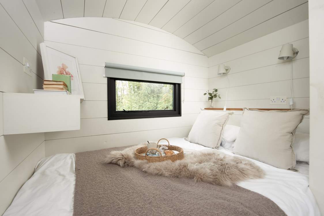 The sumptuous bed and luxurious linens promise a peaceful night's sleep.