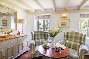 Enjoy a peaceful moment with a good book on the wingback armchair in the sitting-room.