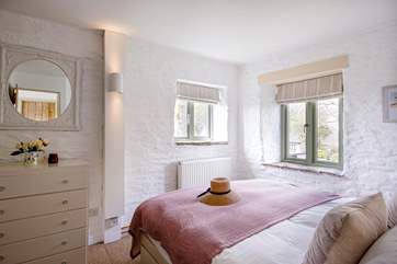 The main bedroom is ever so charming with far reaching views and sea glimpses.