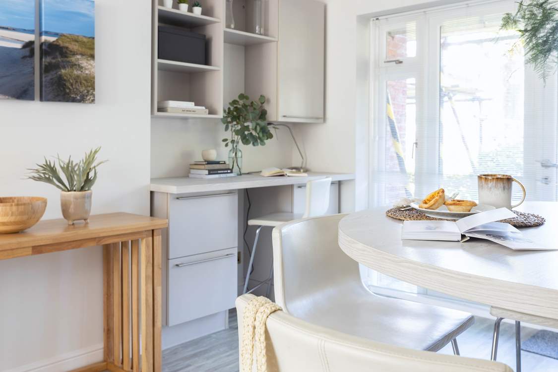 The wooden sideboard is actually a fold out table with four fold out chairs which is perfect for larger parties.