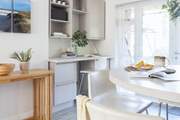 The wooden sideboard is actually a fold out table with four fold out chairs which is perfect for larger parties.