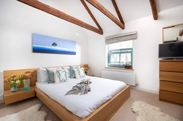 The Old Smokehouse has three light and airy bedrooms and this one enjoys views out over the harbour